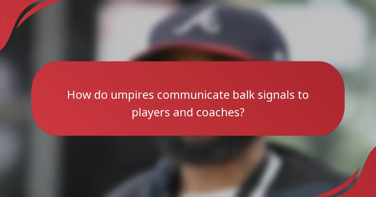 How do umpires communicate balk signals to players and coaches?